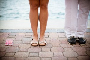image shows child and an adult woman and man's feet or shoes