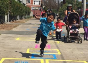 child playing hopscotch in park