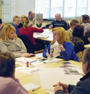 people sat round a table discussing design ideas