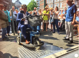 wheelchair user using metal shop ramp