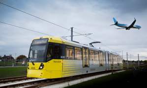tram with plane flying over